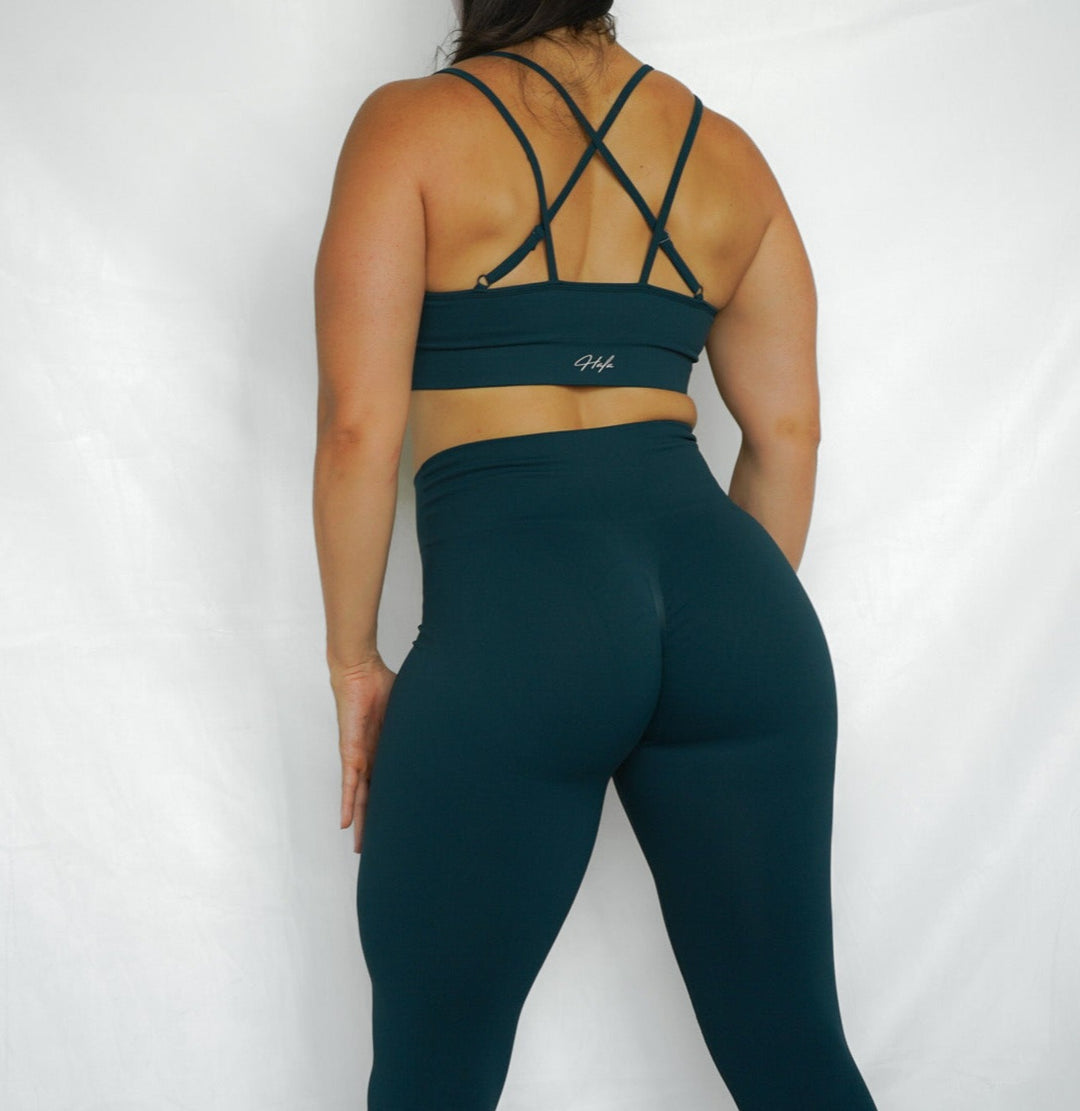 strappy back seamless sports bra with removable cup pads, ultra soft and comfortable oblique side view in deep aquamarine